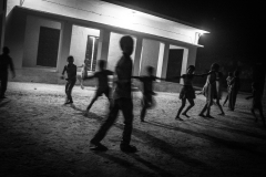 Children playing after sunset. Villagers, regardless of their religion, collect outside homes while a Majlis is in progress, in hopes of getting 'hissa', usually a snack distributed at the end of the majlis.