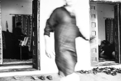 Majlis in progress, as a member of the household rushes to take care of proceedings.